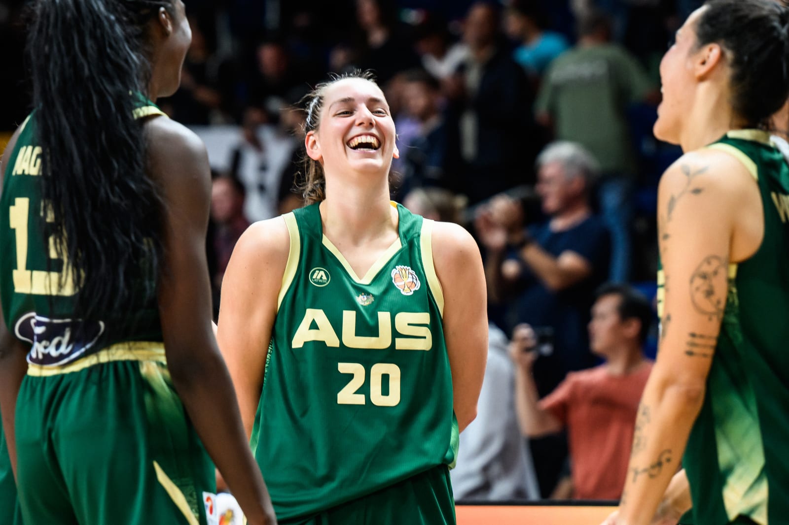 Isobel Borlase smiling with Australia teammates after a World Cup game